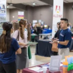 Recruiter speaking with students at 2024 Education Career Fair.