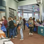 Wide shot of vendors speaking with the public at the Bravos Valley Disability Conference and Resource Fair.