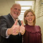 Jody ’99 and Jennifer Ford ’99 giving a thumbs up to the camera showing their Aggie rings.