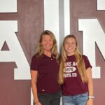 Theresa Wenzel and her daughter, Alison Soltis ’21 posing in front of Texas A&M logo.